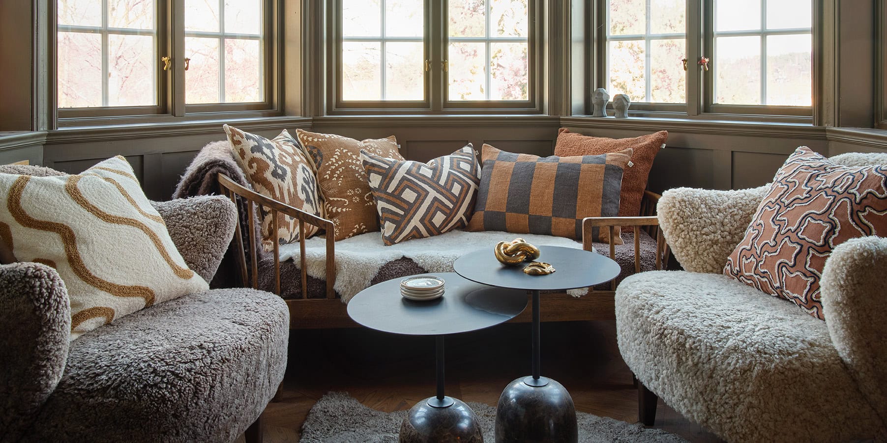 Dark brown and taupe designer cushions in a elegant living room setting