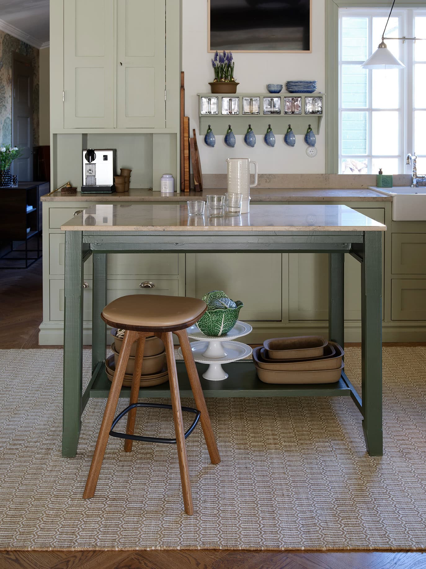 Beige woollen rug Mohini under a kitchen island