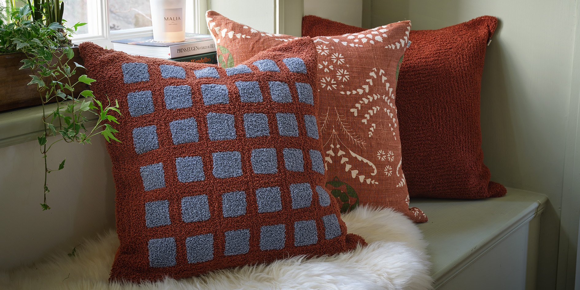 Dark brown and taupe designer cushions in a elegant living room setting