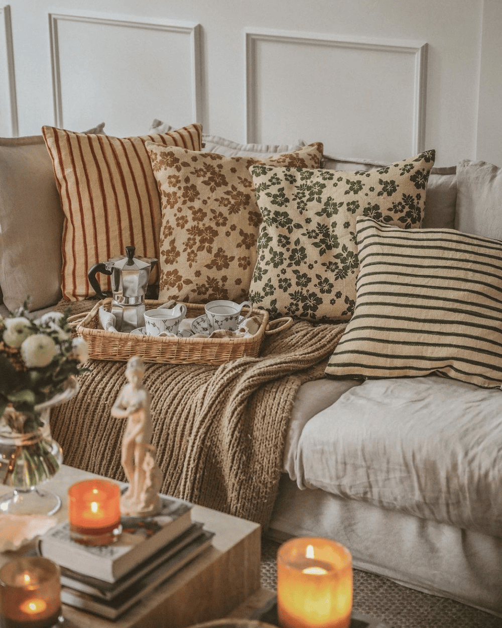 Summery beige pillows in floral and striped patterns
